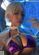A woman in a purple bikini and white gloves.