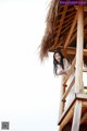 A woman standing on top of a wooden structure.