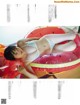 A woman in a white bikini laying on an inflatable watermelon.